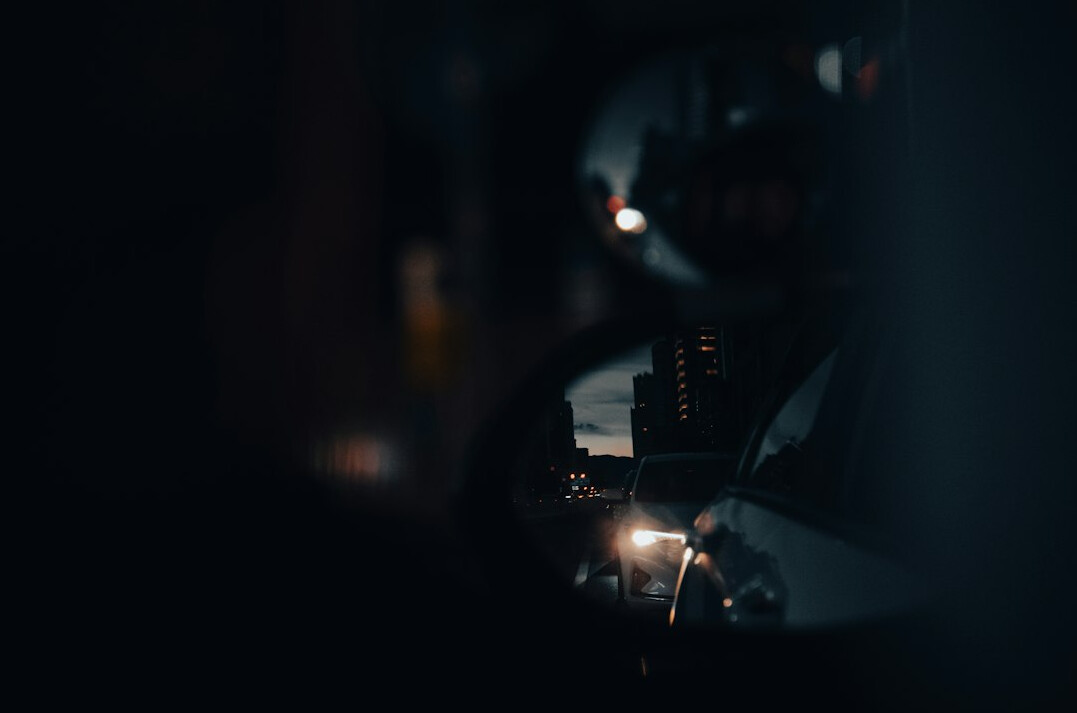 Close-up of a professional vision mixer with illuminated buttons in a dark TV production gallery
