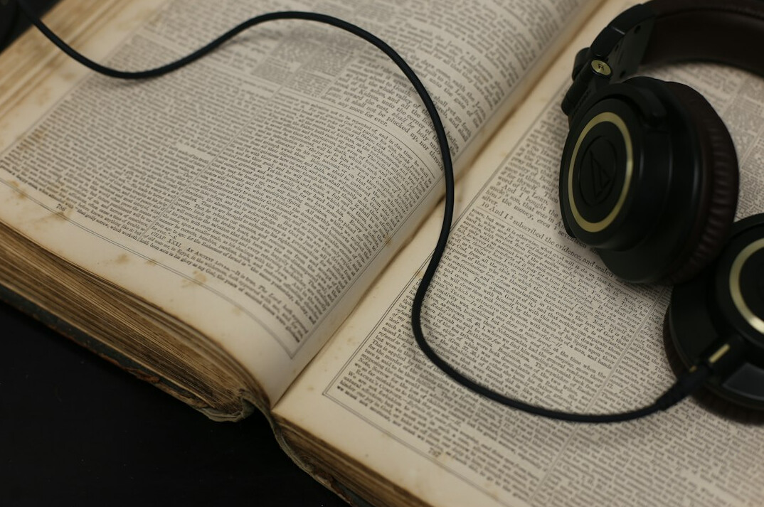 Script with camera cues and a talkback headset on a production desk